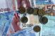 Euro s-a depreciat vineri in fata dolarului la un nou minim al ultimelor 14 luni